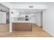 Open concept kitchen with white cabinets, stainless appliances, and wood accent paneling at 3459 One Nation Ave, Las Vegas, NV 89121