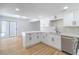 This bright kitchen features white cabinets, stainless steel appliances, and hardwood floors at 3459 One Nation Ave, Las Vegas, NV 89121