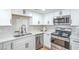 Well-lit kitchen features stainless steel appliances, sleek white cabinetry, and modern fixtures at 3459 One Nation Ave, Las Vegas, NV 89121