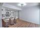 Bright, open kitchen features white cabinets, modern lighting, and a breakfast bar with seating at 3459 One Nation Ave, Las Vegas, NV 89121