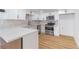 Bright kitchen features white cabinets, stainless steel appliances, and quartz countertops at 3459 One Nation Ave, Las Vegas, NV 89121