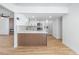 Bright kitchen boasts white cabinets, stainless steel appliances, and stylish wood accents for a modern aesthetic at 3459 One Nation Ave, Las Vegas, NV 89121