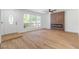 Bright living room featuring wood floors, modern fireplace, and large windows with a view of the outdoors at 3459 One Nation Ave, Las Vegas, NV 89121