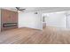 Bright living room with wood floors, a modern fireplace, and an open floor plan leading into the dining area at 3459 One Nation Ave, Las Vegas, NV 89121