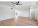 Expansive living room with wood-look flooring and modern ceiling fan at 3459 One Nation Ave, Las Vegas, NV 89121