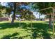Community park with mature trees, green grass, playground, and picnic area at 3459 One Nation Ave, Las Vegas, NV 89121