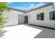 Private patio with white concrete and green landscaping at 3459 One Nation Ave, Las Vegas, NV 89121