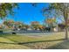 Community basketball court surrounded by green grass and mature trees at 3618 Auckland Castle St, Las Vegas, NV 89135