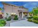 A view of the rear exterior showing the patio, desert landscaping, and the architecture of the property at 3618 Auckland Castle St, Las Vegas, NV 89135