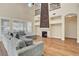 Spacious living room with a striking stone fireplace, high ceilings, and a comfortable grey sofa at 3618 Auckland Castle St, Las Vegas, NV 89135