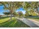 A walking path lined with trees and green grass in the community park at 3618 Auckland Castle St, Las Vegas, NV 89135