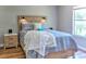 Comfortable bedroom featuring a wooden bed frame, stylish headboard, and complementary grey bedding near a window at 4200 S Valley View Blvd # 2081, Las Vegas, NV 89103