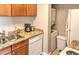 Efficient kitchen featuring stainless steel sink, granite counters, and stackable washer/dryer combo at 4200 S Valley View Blvd # 2081, Las Vegas, NV 89103