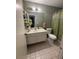 Bathroom features an olive-green wall, a vanity with a large mirror, and a shower with an olive-green shower curtain at 445 Sam Jonas Dr, Las Vegas, NV 89145