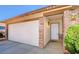 Charming home exterior with a spacious garage, front door entrance, and manicured shrubs at 445 Sam Jonas Dr, Las Vegas, NV 89145