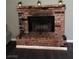 Close-up of a brick fireplace with decorative accents on top, set on dark wood floors at 445 Sam Jonas Dr, Las Vegas, NV 89145