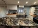 Bright and modern kitchen with stainless steel appliances and a spacious center island with seating at 445 Sam Jonas Dr, Las Vegas, NV 89145