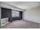Spacious bedroom with carpet floors, an accent wall, and a window with neighborhood views at 4693 Mill Valley Dr, Las Vegas, NV 89120
