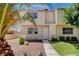 Charming two-story home with a well-maintained front yard featuring desert landscaping and mature palm trees at 4693 Mill Valley Dr, Las Vegas, NV 89120