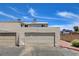 Exterior view of attached garages featuring neutral doors and siding, great for parking at 4693 Mill Valley Dr, Las Vegas, NV 89120