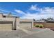 Garages with neutral doors and siding, set against a bright blue sky and street at 4693 Mill Valley Dr, Las Vegas, NV 89120