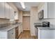 Charming kitchen featuring granite countertops, white cabinets, and modern appliances for a stylish cooking experience at 4693 Mill Valley Dr, Las Vegas, NV 89120
