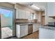 The kitchen features white cabinetry, granite countertops, stainless steel appliances, and access to the patio at 4693 Mill Valley Dr, Las Vegas, NV 89120