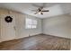 Spacious living room featuring wood-look floors, a ceiling fan, and a window for natural light at 4693 Mill Valley Dr, Las Vegas, NV 89120