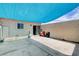 Enclosed patio area with blue shade sail, concrete flooring, and door to the home at 4693 Mill Valley Dr, Las Vegas, NV 89120
