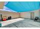 Spacious concrete patio with blue shade cover offering ample space for outdoor activities at 4693 Mill Valley Dr, Las Vegas, NV 89120
