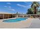 Sparkling community pool with seating area and lush palms, ideal for relaxation at 4693 Mill Valley Dr, Las Vegas, NV 89120
