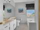 Light and airy bathroom with a modern vanity, large mirror and tiled floor at 471 Fallwood Ln, Las Vegas, NV 89107