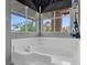 Bright bathroom featuring an elegant white soaking tub next to a sunny window at 471 Fallwood Ln, Las Vegas, NV 89107