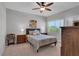 Inviting bedroom with a ceiling fan, large window offering natural light and a cozy, plush bed at 471 Fallwood Ln, Las Vegas, NV 89107