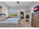 Comfortable bedroom with a large window providing natural light and an organized closet at 471 Fallwood Ln, Las Vegas, NV 89107