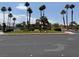 View of a community entrance with palm trees and lush landscaping at 471 Fallwood Ln, Las Vegas, NV 89107