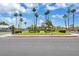 Well-maintained community entrance with palm trees, landscaping, and an inviting building at 471 Fallwood Ln, Las Vegas, NV 89107