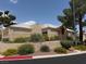 Beige single-story home with a desert landscape, wrought iron fence, and terracotta-style roof at 471 Fallwood Ln, Las Vegas, NV 89107