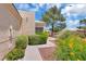 Manicured front yard featuring desert landscaping and charming walkway at 471 Fallwood Ln, Las Vegas, NV 89107