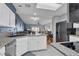 Open concept kitchen with granite countertops and stainless steel appliances at 471 Fallwood Ln, Las Vegas, NV 89107