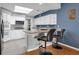 Charming kitchen featuring granite countertop breakfast bar and sleek appliances at 471 Fallwood Ln, Las Vegas, NV 89107