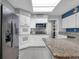 Bright kitchen featuring white cabinets, granite counters, and modern appliances at 471 Fallwood Ln, Las Vegas, NV 89107