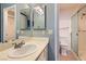 Well-lit bathroom featuring a sleek sink, a toilet, and a glass-enclosed shower at 4718 Nara Vista Way # 104, Las Vegas, NV 89103