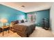 Comfortable bedroom with turquoise walls, a window view, and carpeted floor at 4718 Nara Vista Way # 104, Las Vegas, NV 89103