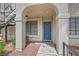 Condo front door with blue door and entry under archway at 4718 Nara Vista Way # 104, Las Vegas, NV 89103