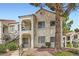 Charming two-story condo with stucco siding, balcony, and mature tree at 4718 Nara Vista Way # 104, Las Vegas, NV 89103