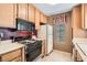 Compact kitchen featuring tiled floors, cabinets, and appliances at 4718 Nara Vista Way # 104, Las Vegas, NV 89103