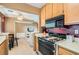 Kitchen with wooden cabinets and modern appliances, including a gas range at 4718 Nara Vista Way # 104, Las Vegas, NV 89103