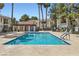 Community swimming pool with sun loungers, tall palm trees and a pool house at 4718 Nara Vista Way # 104, Las Vegas, NV 89103