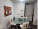 Dining area featuring a modern glass table and contemporary artwork at 4730 E Craig Rd # 1155, Las Vegas, NV 89115
